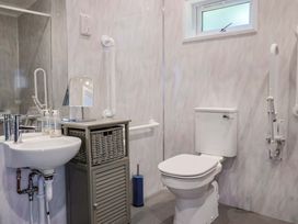 A bathroom with a sink and toilet at Cedar 1 in Pinewood Retreat in Rousdon near Lyme Regis