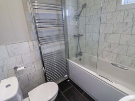 A bathroom with a bathtub and shower at Cedar 1 in Pinewood Retreat in Rousdon near Lyme Regis