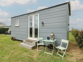 A cabin with seating area outside at Llewelyn Ty Croes