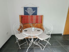 A dining area with a bistro table and two chairs at Llewelyn in Ty Croes