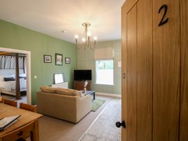 A living room with a couch and television at Apartment 2 The Bridge at Stanford Hotel near Great Witley