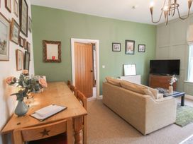 A living room with a couch and TV at Apartment 2 The Bridge at Stanford Hotel near Great Witley