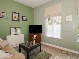 A living room with a television and sofa at Apartment 2 The Bridge at Stanford Hotel near Great Witley