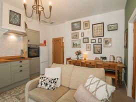 A living room with a sofa and dining table at Apartment 2 The Bridge at Stanford Hotel near Great Witley