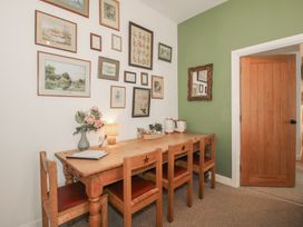 A dining room with a wooden table and chairs at Apartment 2 The Bridge at Stanford Hotel near Great Witley