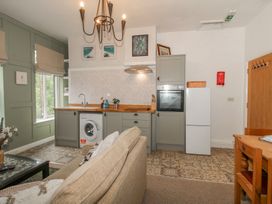 A kitchen with appliances and a dining area at Apartment 2 The Bridge at Stanford Hotel near Great Witley