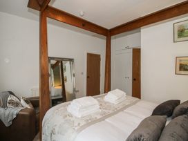 A bedroom with a bed and mirror at Apartment 2 The Bridge at Stanford Hotel near Great Witley