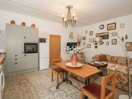 A kitchen with a dining table and chairs at Apartment 1 The Bridge at Stanford Hotel near Great Witley