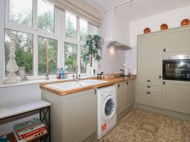 A kitchen with a sink and washing machine at Apartment 1 The Bridge at Stanford Hotel near Great Witley