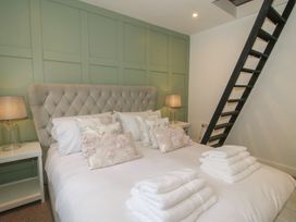 A bedroom with a bed and stairs at Apartment 1 The Bridge at Stanford Hotel near Great Witley