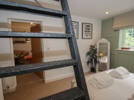 A bedroom with a ladder and a bed with pillows at Apartment 1 The Bridge at Stanford Hotel near Great Witley
