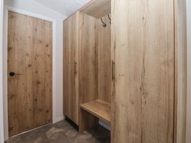 A hallway with storage cabinet and hooks at Meadows Park 2 in Great Hatfield near Hornsea