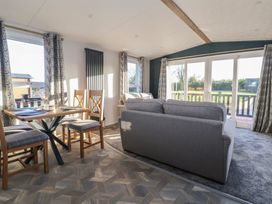 A living room featuring a table and chairs at Meadows Park 2 Great Hatfield near Hornsea