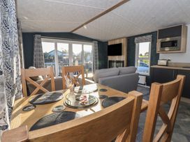 A living room with a dining table and sofa at Meadows Park 2 Great Hatfield near Hornsea