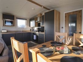 A kitchen with appliances and dining area at Meadows Park 2 Great Hatfield near Hornsea