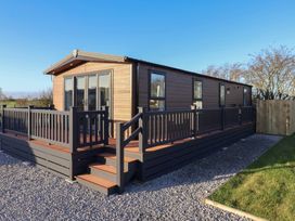 A house with decking and stairs at Meadows Park 2 Great Hatfield near Hornsea