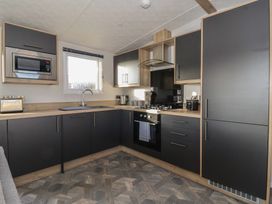 A kitchen with cabinets and appliances at Meadows Park 3 in Great Hatfield near Hornsea