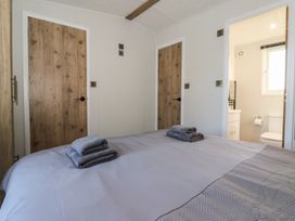 A bedroom with a bed and towels at Meadows Park 3 in Great Hatfield near Hornsea