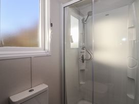 A bathroom with a shower and a toilet at Meadows Park 3 Great Hatfield near Hornsea