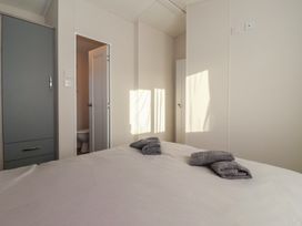 A bedroom with a bed and towels on it at Meadows Park 4 near Hornsea