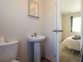 A bathroom with a toilet and sink at Meadows Park 4 Great Hatfield near Hornsea