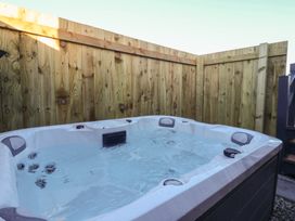 A hot tub surrounded by wooden fencing at Meadows Park 5 Great Hatfield near Hornsea