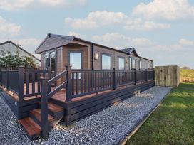 A property with a deck and railing at Meadows Park 5 in Great Hatfield near Hornsea