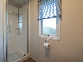 A bathroom with a shower and window at Meadows Park 5 in Great Hatfield near Hornsea