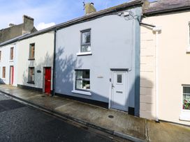 A house exterior with a sidewalk and door at Rose Cottage in Killala, County Mayo