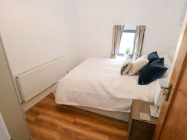 A bedroom with a bed and window at Rose Cottage in Killala, County Mayo