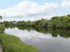 A river surrounded by trees and grass at Rose Cottage in Killala, County Mayo