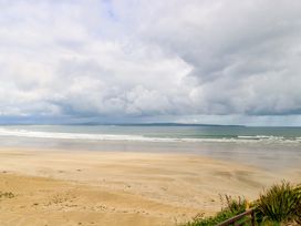 A beach with waves and clouds at Rose Cottage in Killala, County Mayo