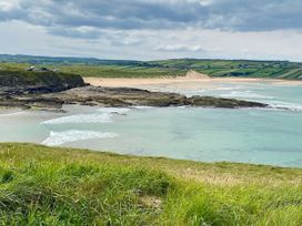 A beach with cliffs and water at Rose Cottage in Killala, County Mayo