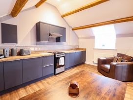 A kitchen with cabinets and appliances at Clegir Bach in Corwen