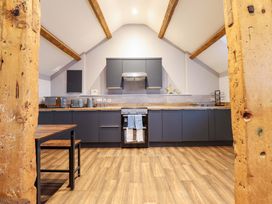 A kitchen with cabinets and appliances at Clegir Bach near Betws Gwerfil Goch