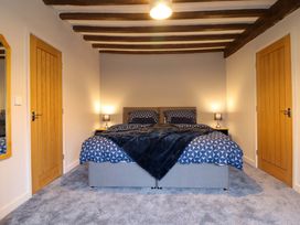 A bedroom with a bed and lamps at Clegir Bach in Betws Gwerfil Goch near Corwen