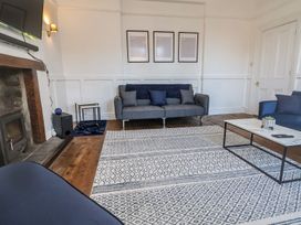 A living room with a sofa and armchair at Mariners Lee