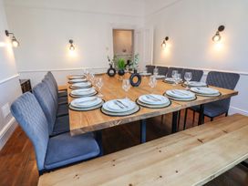 A dining room with a large table set for dinner at Mariners Lee