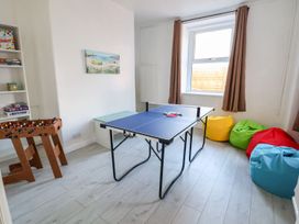 A game room with a table tennis table and bean bags at Mariners Lee
