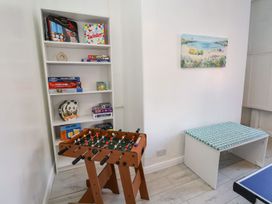 A game room with a foosball table and a shelf of board games at Mariners Lee