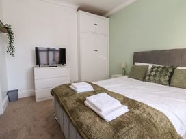 A bedroom with a bed and television at Mariners Lee