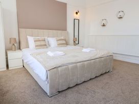 A bedroom with a bed and bedside table at Mariners Lee 