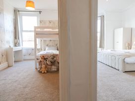 A bedroom with a bunk bed and stuffed animals at Mariners Lee in 