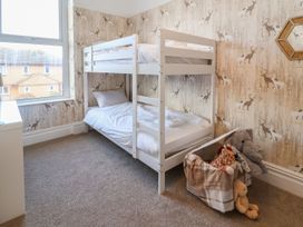 A bedroom with a bunk bed and stuffed animals at Mariners Lee