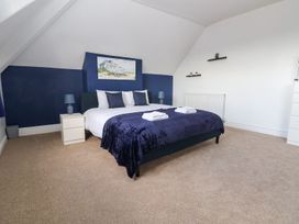 A bedroom with a bed and bedside table at Mariners Lee 