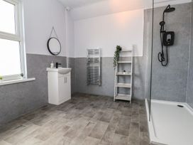 A bathroom with a shower and sink at Mariners Lee