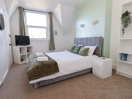 A bedroom with a bed and television at Mariners Lee