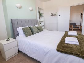 A bedroom with a bed and bedside table at Mariners Lee