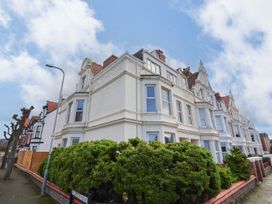 An exterior view of a building with windows and bushes at Mariners Lee