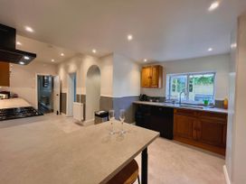 A kitchen with cabinets and appliances at Clarence House in Llandudno